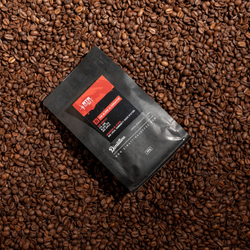 Dimattina limited release The Blend Alternative with RTRFM laying on freshly roasted coffee beans