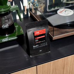 The blend alternative by Dimattina Coffee and RTRFM next to a green mocca master and record player