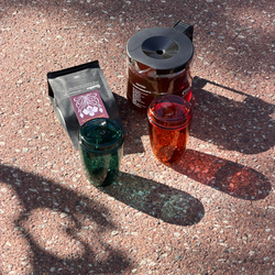 Matriarch coffee bag, two Good Cuppa cups and Moccamaster on pavement