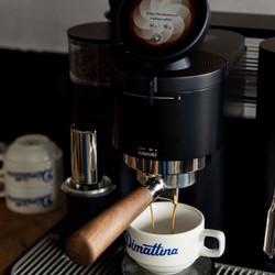 A close up of a Meraki home espresso machine pulling a shot of espresso