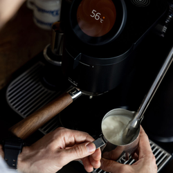 A close of up steaming milk on a Meraki espresso machine