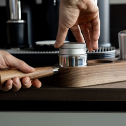 A close up of someone using the Meraki espresso accessories kit
