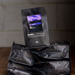 A bag of Ronnie's coffee stacked on other Dimattina coffee bags